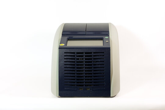 Dual-block PCR thermal cycler with two heating compartments, digital display, ventilation grille and control panel, isolated on a white background.