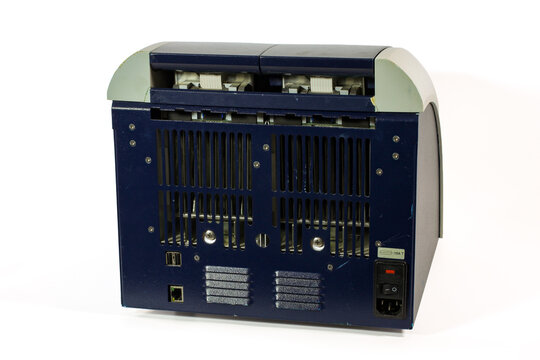 Laboratory PCR thermal cycler with dual heating compartments, electronic display, cooling vents and USB ports, isolated on a white background.
