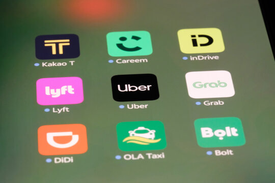 Shanghai,China-Sep.6th 2026: ride-hailing app icons including Kakao T, Careem, inDrive, Lyft, Uber, Grab, DiDi, OLA Taxi, and Bolt displayed on a smartphone screen.