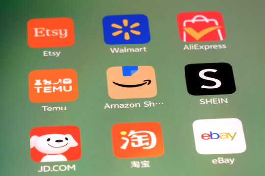 Shanghai,China-Sep.6th 2026: phone screen displaying icons for global e-commerce and shopping apps, including Etsy, Walmart, AliExpress, Temu, Amazon Shopping, SHEIN, JD.COM, Taobao, and eBay.
