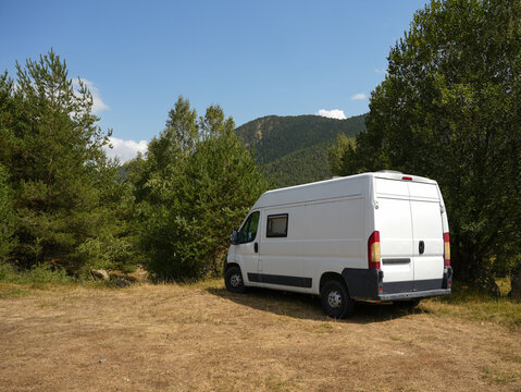 White Van Camping in Scenic Mountain Landscape