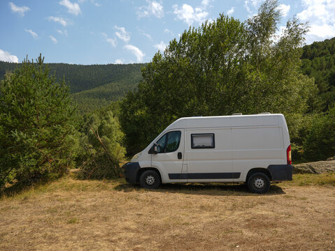 White Van Parked in Mountain Forest Landscape