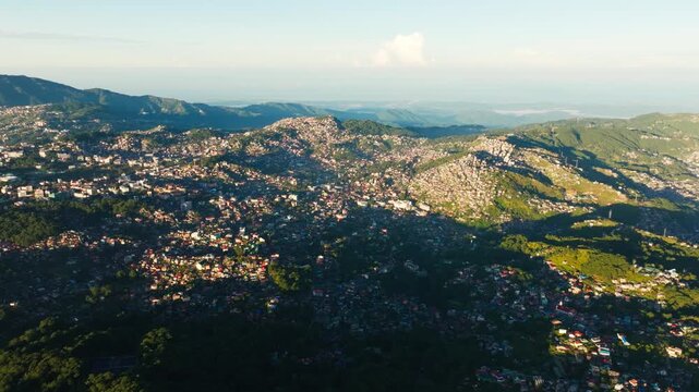 Drone gently turns right over Baguio City at sunrise in Benguet, Philippines