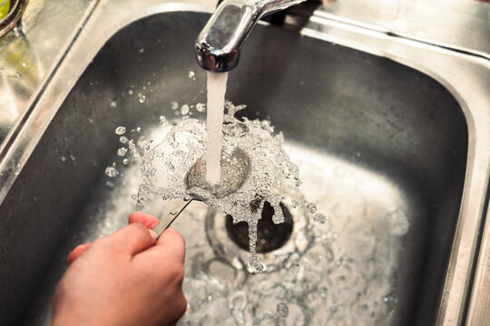 Washing Spoon Under Running Tap Water