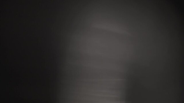 Soft atmospheric light leak featuring subtle rainbow lens glare and shimmering bokeh on a black background. Perfect drag-and-drop blend overlay for video editors and motion graphics designers.
