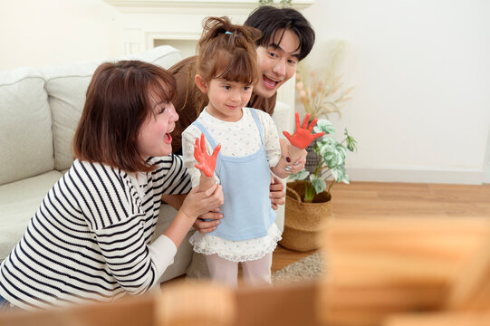 Family Painting Together at Home With Young Girl Working on Her Artwork