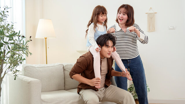 Family Plays Together in a Living Room on a Sofa