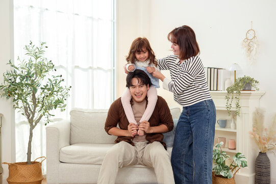 Family Plays Together in a Living Room on a Sofa