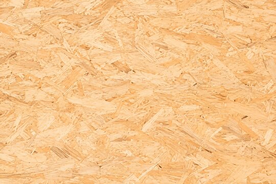 OSB wood panel texture, oriented strand board background, compressed wooden chipboard surface for construction and interior design