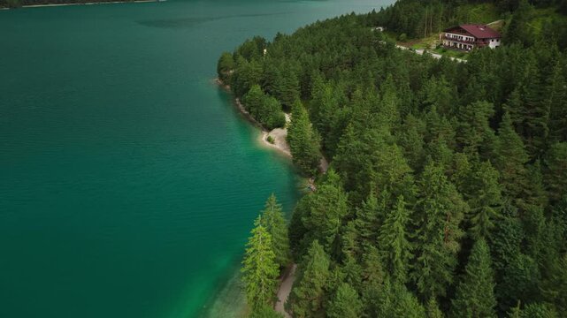 Scenic view of Achensee in Tyrol, Austria, surrounded by lush green vegetation and natural lakeshore landscape - drone shot