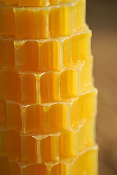 Golden beeswax honeycomb structure close up showing natural texture and sweet honey
