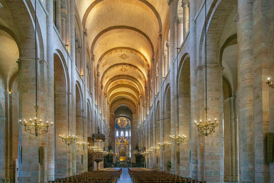 Symmetrical interior view of Basilica of Saint-Sernin in Toulouse, France. Central nave leading to the historic altar