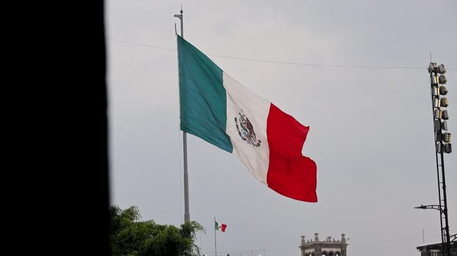 Large Mexican Flag Waving On Flagpole In Zocalo Square Mexico City