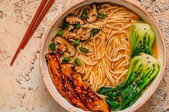 Vegan miso ramen noodle soup with eryngii and shiitake mushrooms, pak choi cabbage