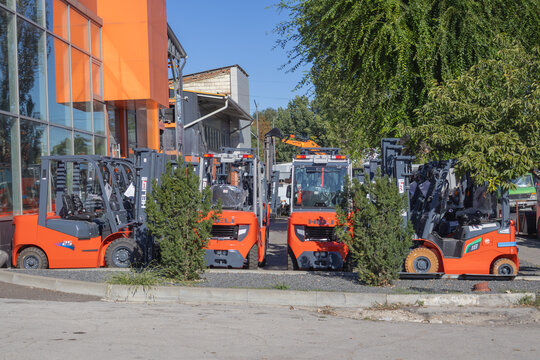 Orange HELI forklifts displayed outside an industrial equipment showroom building - Chisinau Moldova - September 05 2026
