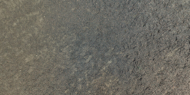 view from above on texture of gravel road among grass field