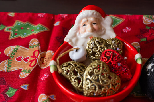 Ceramic Santa Claus Bowl Filled with Gold and Red Heart Ornaments