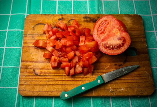 Top View Diced Red Tomatoes and Half Tomato on Wooden Board