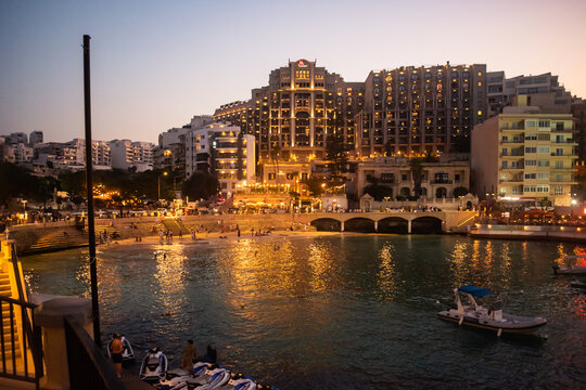 Scenic Balluta Bay at evening illuminated with lights reflecting on the sea, St. Julian's MALTA