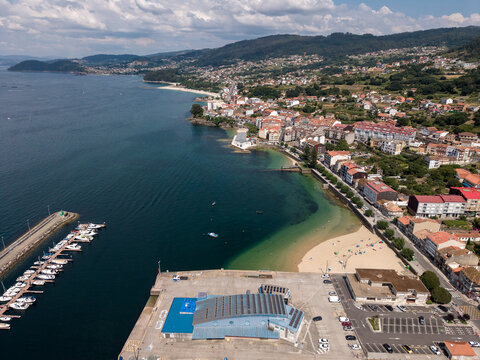 Bueu waterfront with marina, beach, and coastal town