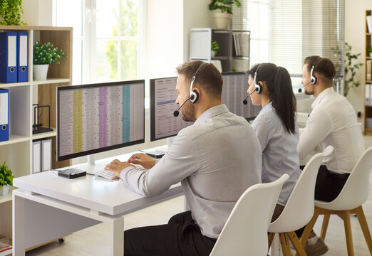 Callcenter agents with headsets support customers daily. They work at computers in office using technology to resolve inquiries and ensure communication. Customer service and teamwork concept.