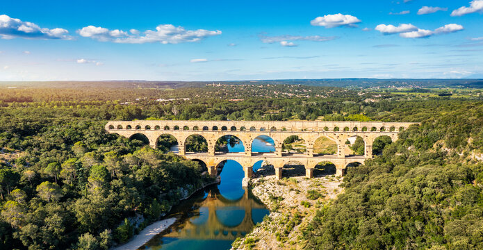 Exploring the majestic Pont du Gard aqueduct in France, discover the stunning architecture of the ancient Pont du Gard aqueduct in southern France. River Gard, Languedoc-Roussillon, France.