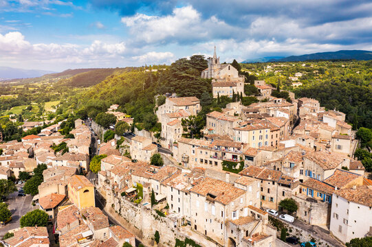 Village of Bonnieux showcasing architecture and serene landscapes, Provence, Luberon, France. Stunning views of Bonnieux medieval village surrounded by lush greenery and hills in Provence.