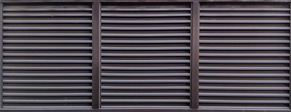 ​Dark brown metallic louver window shutters texture background, horizontal aluminium slats for ventilation and privacy