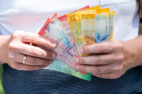Male Hands Fan Out Swiss Francs Currency Banknotes Stack for Financial Success and Deposit