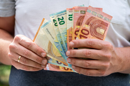 Male Hands Holding and Counting Stack of Euro Currency Banknotes for Business Finance Concept