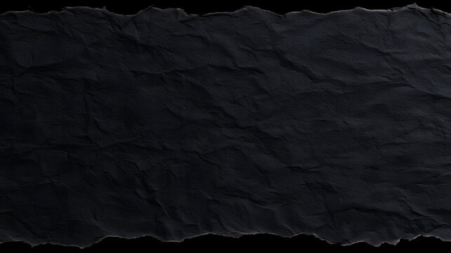 isolated crumpled black paper with torn edges for a design element set against a rough textured background