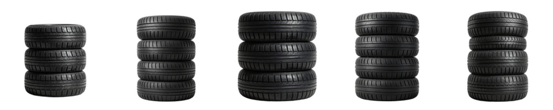 Stacks of car tires showing various sizes against black backdrop for automotive industry
