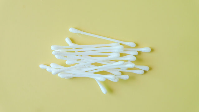 wood swabs or Cotton swabs on a color background.