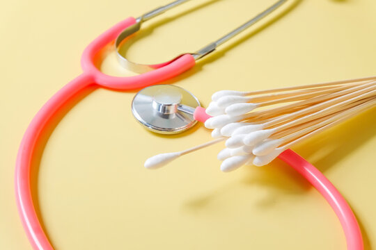 wood swabs or Cotton swabs with stethoscope on background.