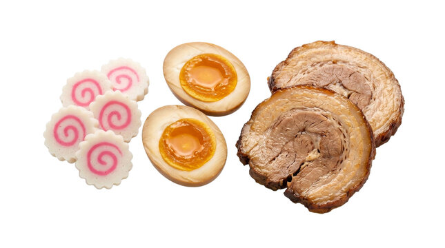 Delicious ramen toppings including chashu pork, marinated eggs, and narutomaki fish cakes