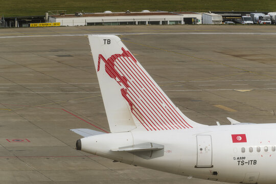 Geneva, Switzerland - August 31, 2026 : signs and logotype on the fuselage and tail on a Boeing 737‑600 of Tunisair on the runway at Geneva airport