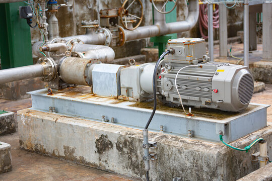 Screw pump with induction motor connected to chemical pipeline in the process area of a chemical factory,