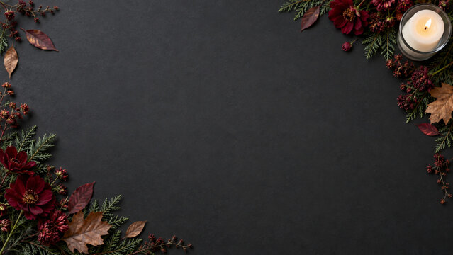Autumn floral frame with burning candle on black background