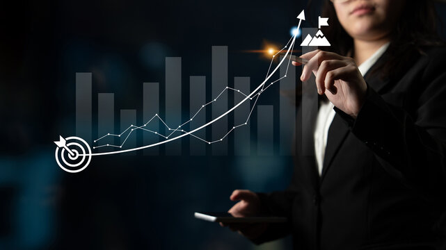 Businesswoman analyzing financial growth with graphs and charts, showcasing data insights in a professional setting. The image represents success and strategic planning. Ledger