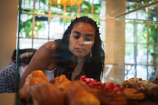 Mujer observando la pasteler&iacute;a en una cafeter&iacute;a