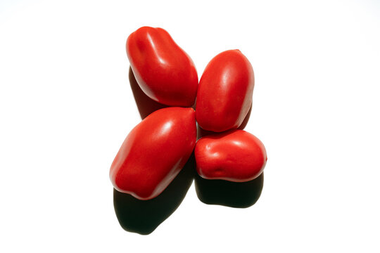Flat lay top view of a red Pepper tomato on a white background with a shadow. Focus on healthy food, citrus, vitamins, and diet concepts.