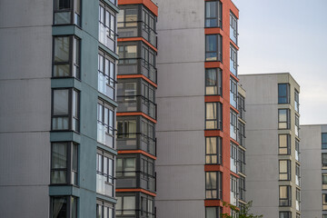 Modern apartment towers with colorful enclosed glass balconies. © Trygve