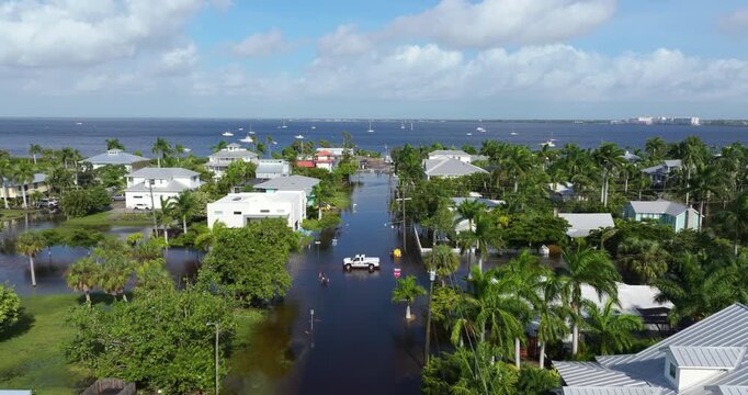 Flooding in Florida caused by tropical storm from hurricane rainfall. Suburb houses in residential community surrounded by flood waters. Aftermath of natural disaster.
