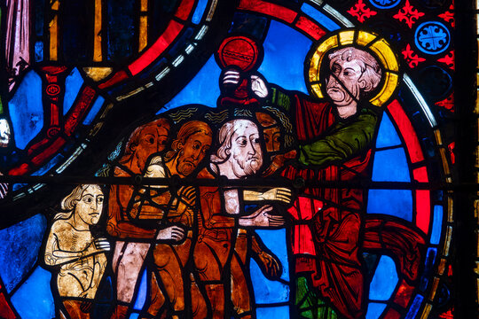 An angel receives Lazarus&rsquo;s soul while the rich man dies in a Gothic stained-glass scene