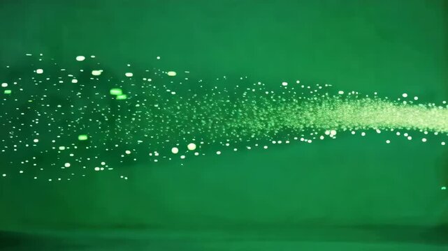 Energetic Green Sparkling Particles Flowing Across Background.
