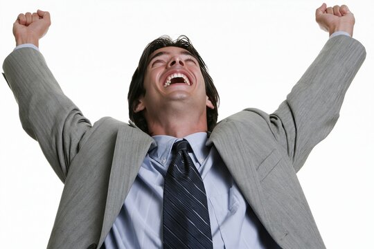 Excited businessman celebrating victory with arms raised high against a white background