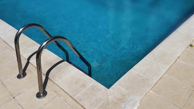 A pool with a ladder and a hand rail