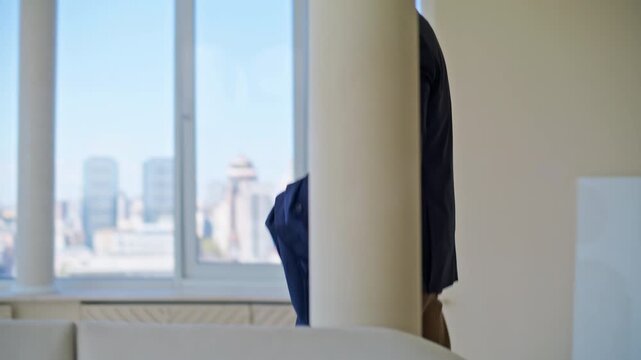 Businessman putting on suit jacket luxury apartment. Man grabbing suitcase.