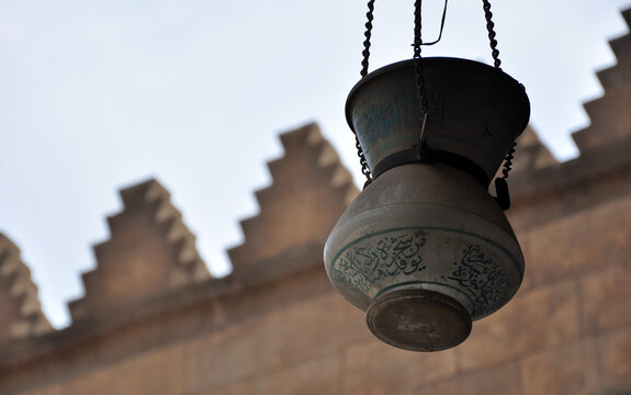 Cairo, Egypt - July 03 2010: close up photo of an old lamp in a mosque, Translation: arabic text