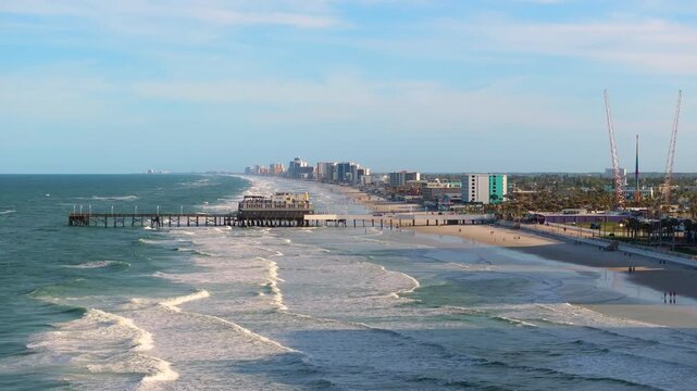 Main Street Pier in Daytona Beach, Florida, a key landmark with nearby hotels and condos forming part of the Atlantic city oceanfront landscape.